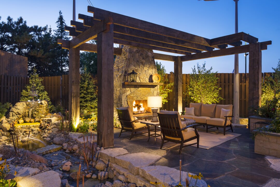 Cozy outdoor patio with fireplace and seating.