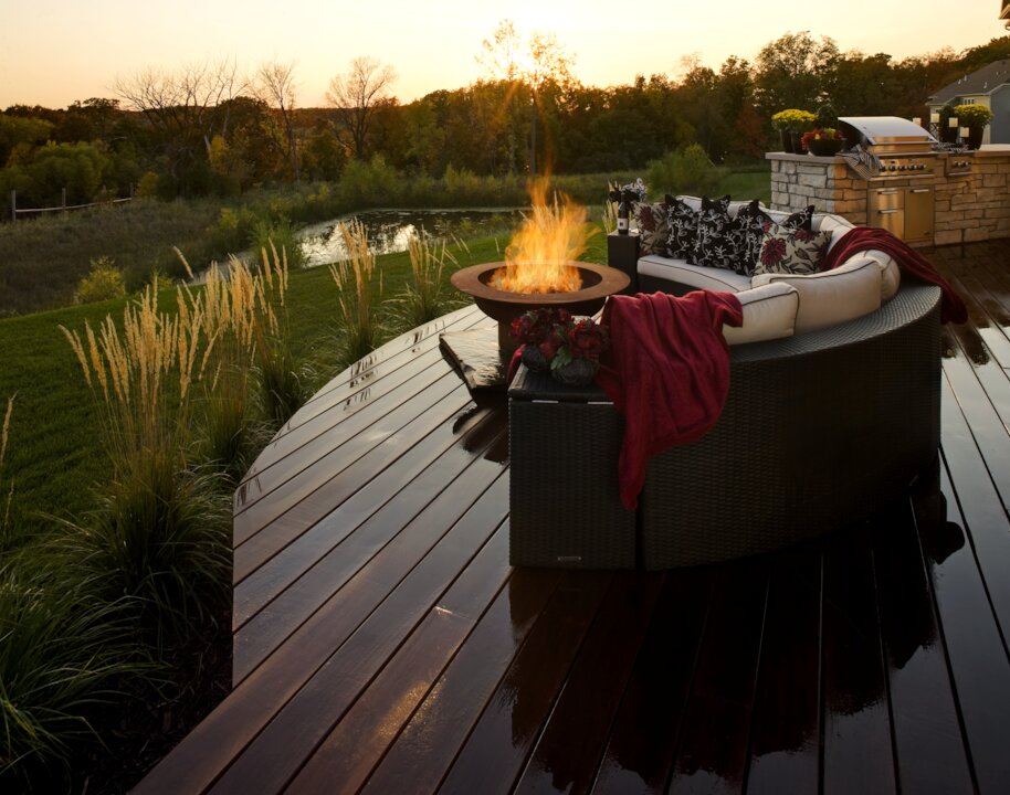 Cozy outdoor patio with fire pit at sunset.