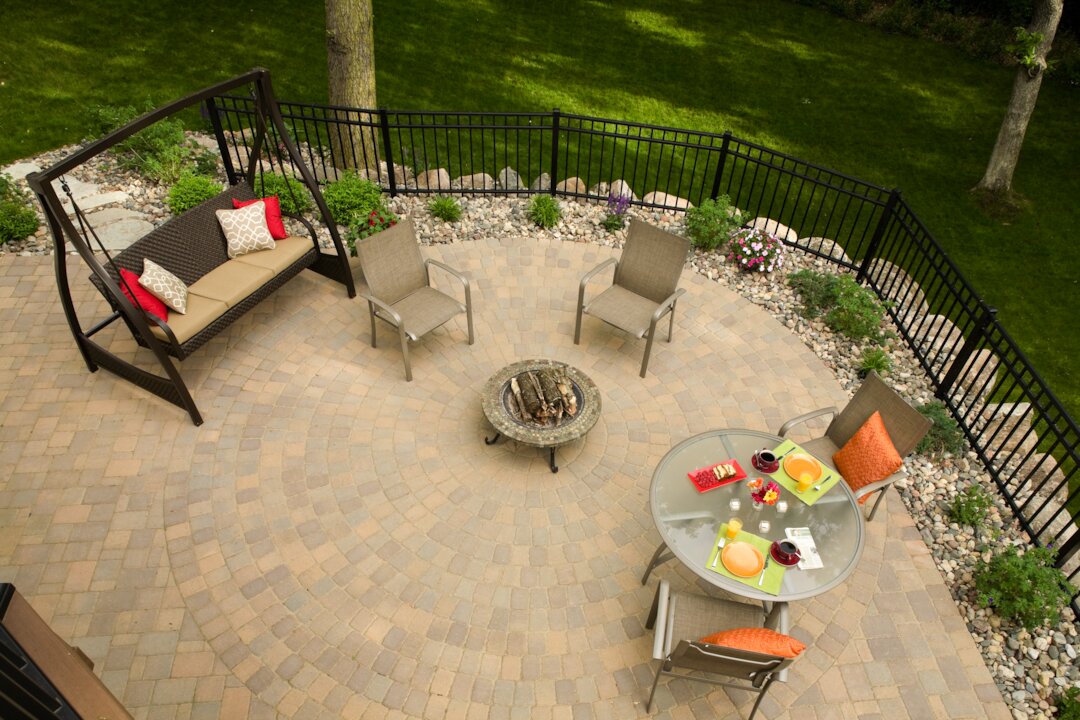 Cozy patio setup with chairs and fire pit.