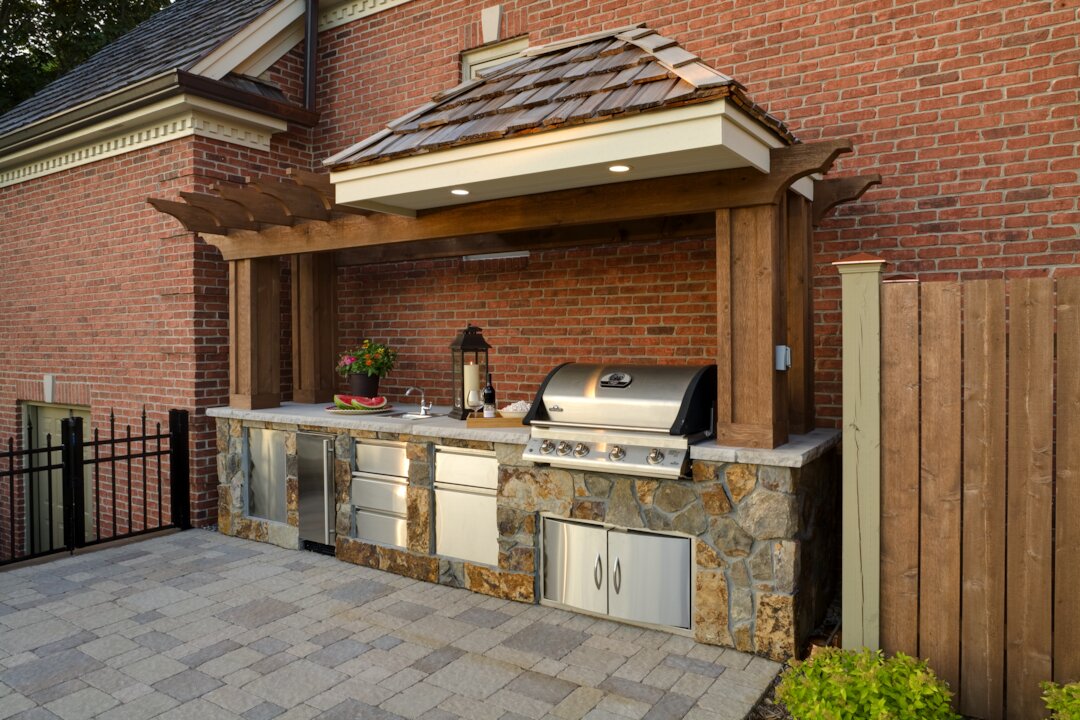 Outdoor kitchen with grill and countertop.