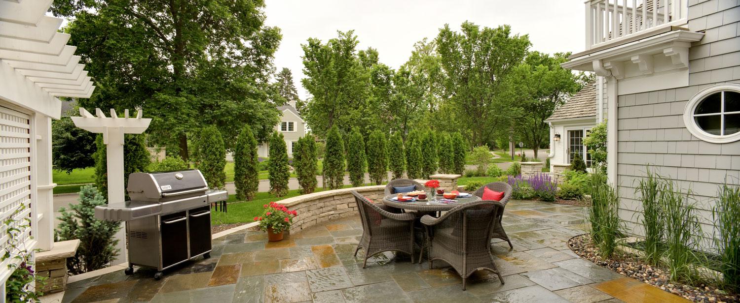 Patio with outdoor dining and grill setup.