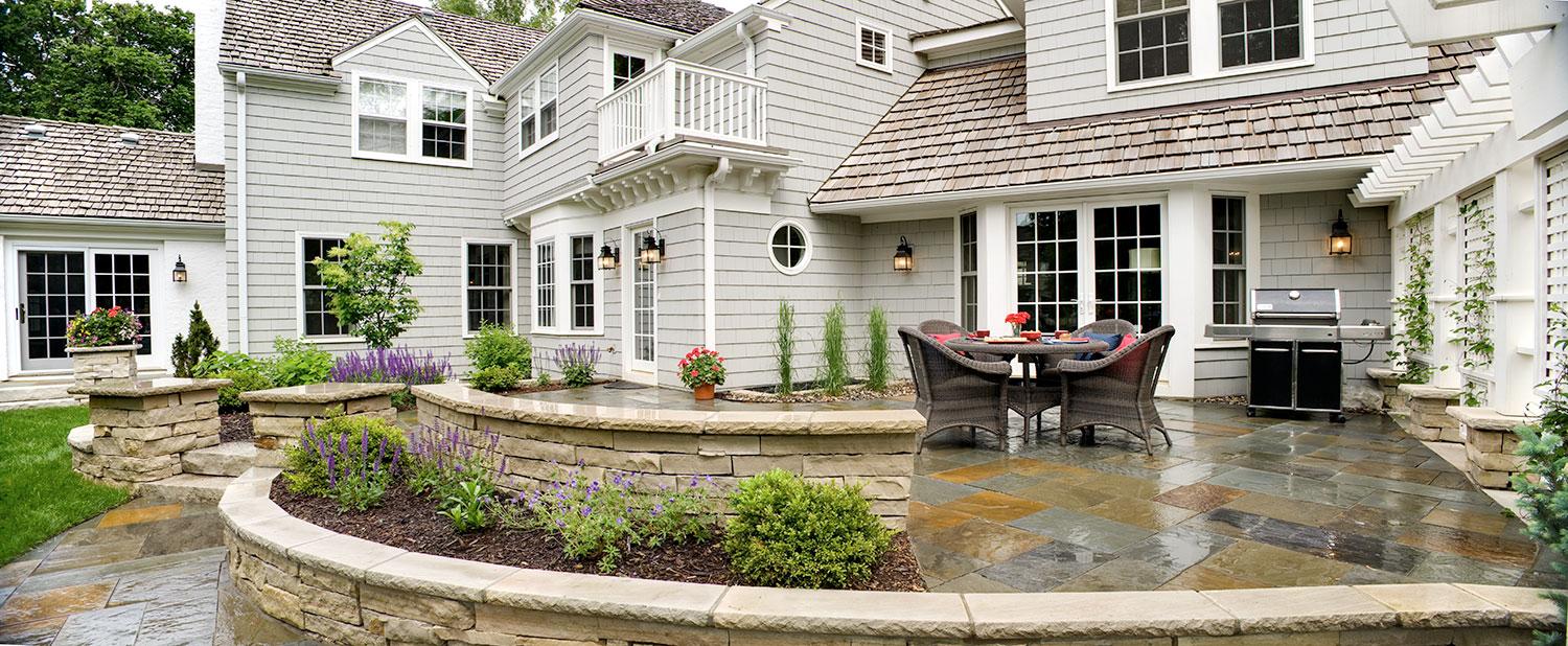 Spacious patio with elegant furniture and garden view.
