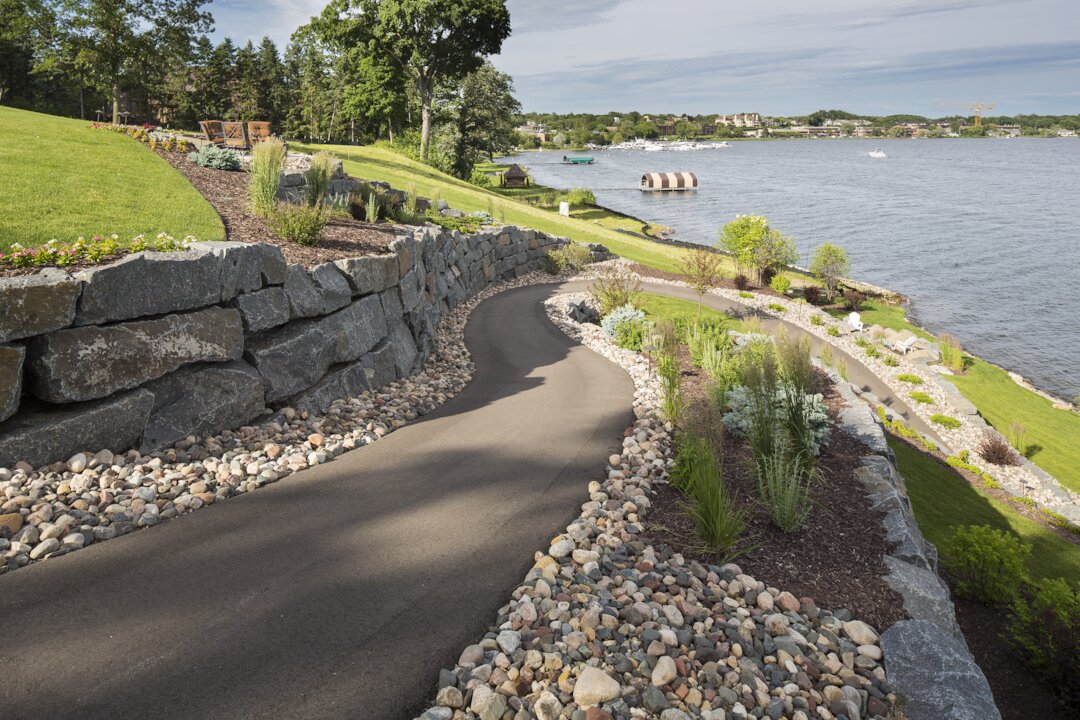 Curved path beside a scenic lake view.