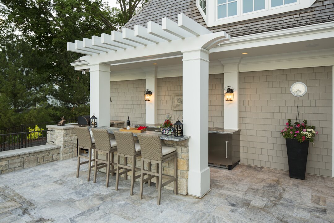 Outdoor patio with bar and stools