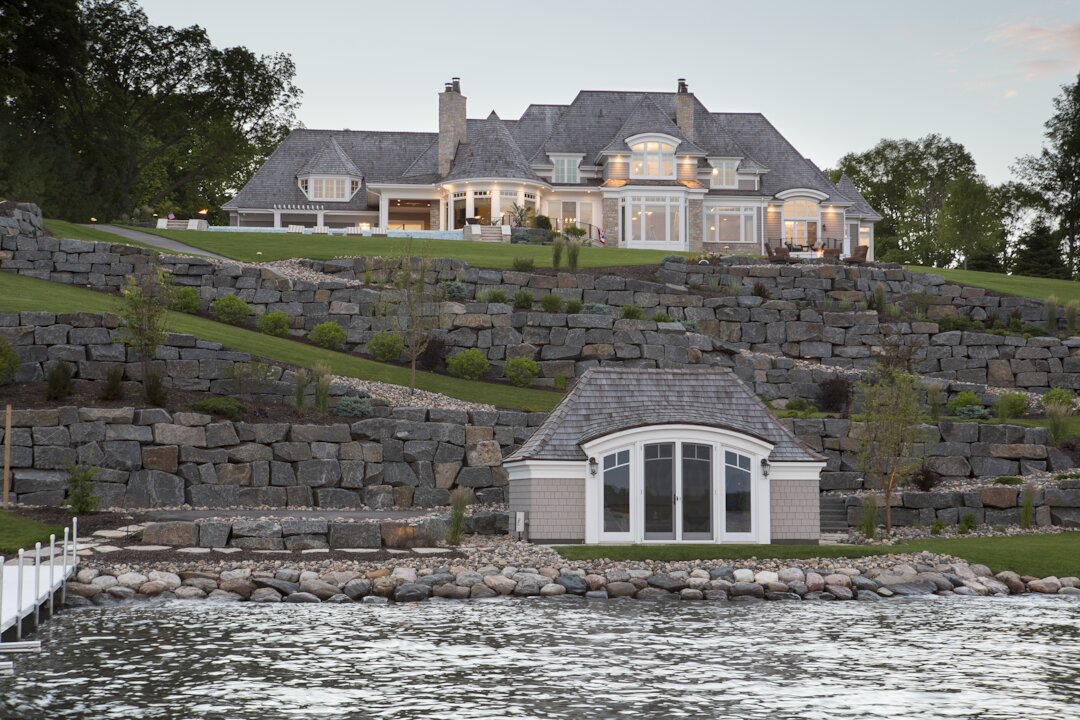 Luxurious lakefront mansion with stone terrace