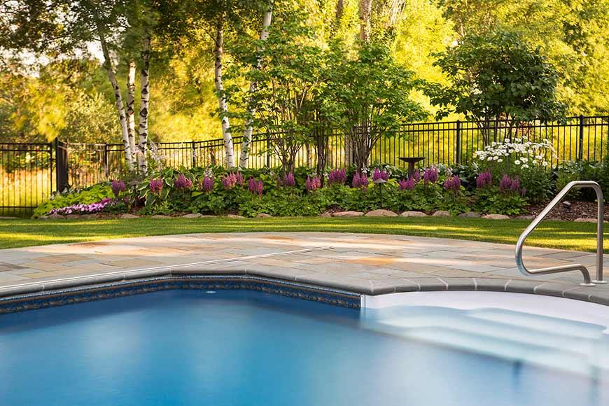 Backyard pool with garden and trees