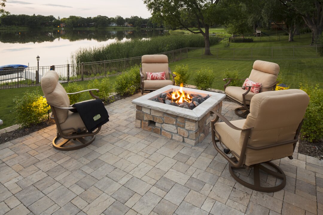 Outdoor patio with fire pit and seating area.
