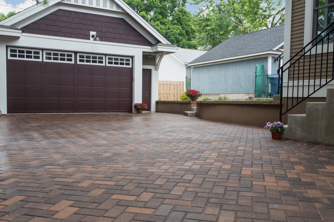 Brick driveway leading to garage door.