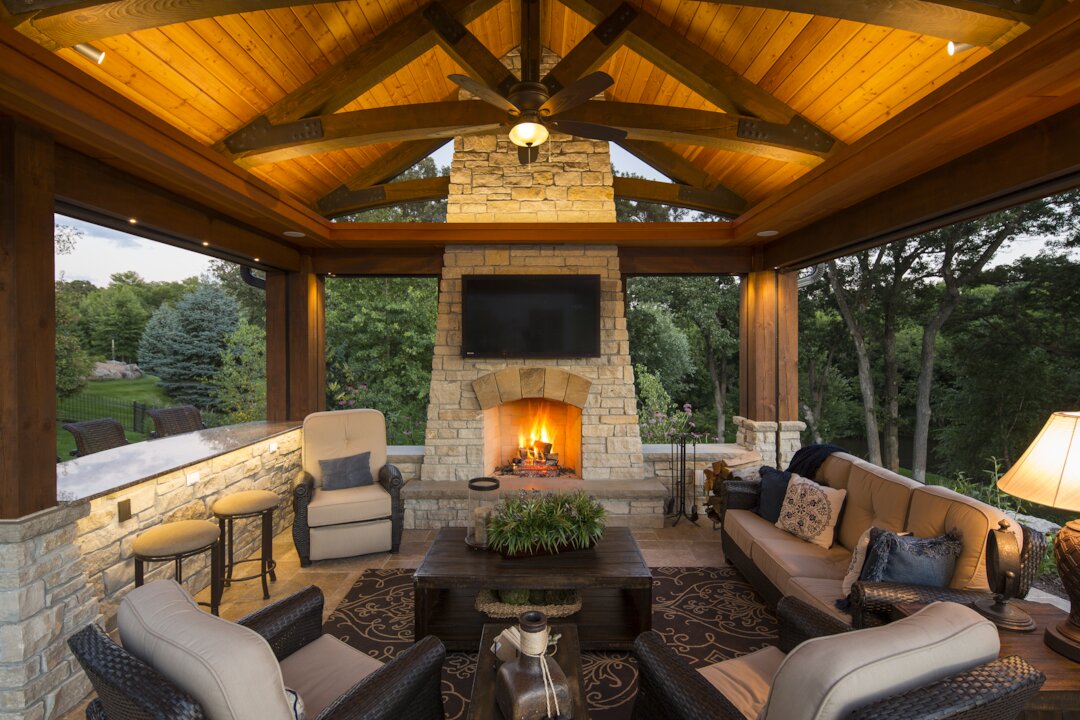 Cozy outdoor patio with fireplace and seating.