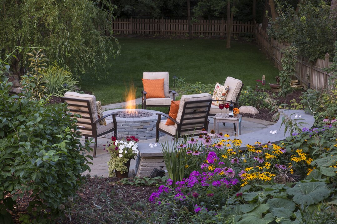 Cozy backyard with fire pit and flowers.