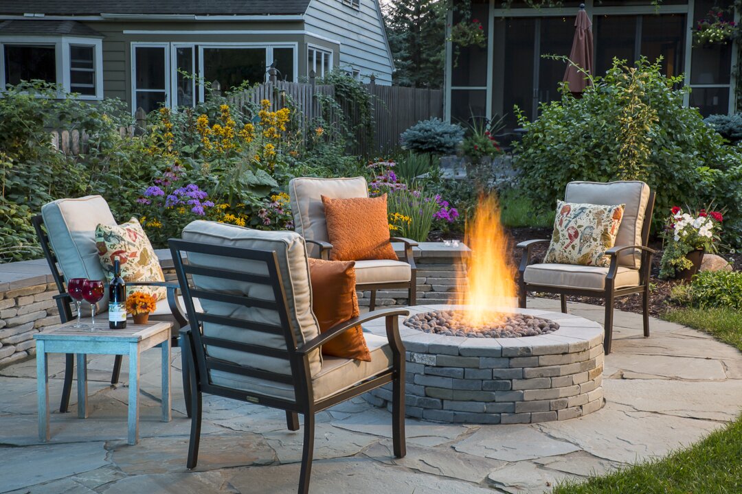 Cozy patio with fire pit and garden seating.