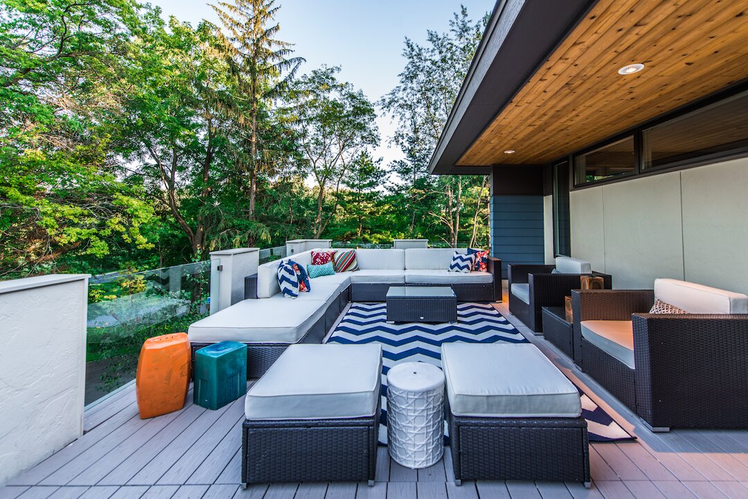 Modern outdoor deck with stylish patio furniture.