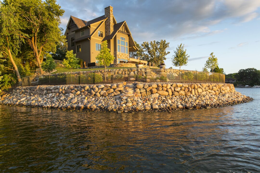 Waterfront house with stone foundation by lake