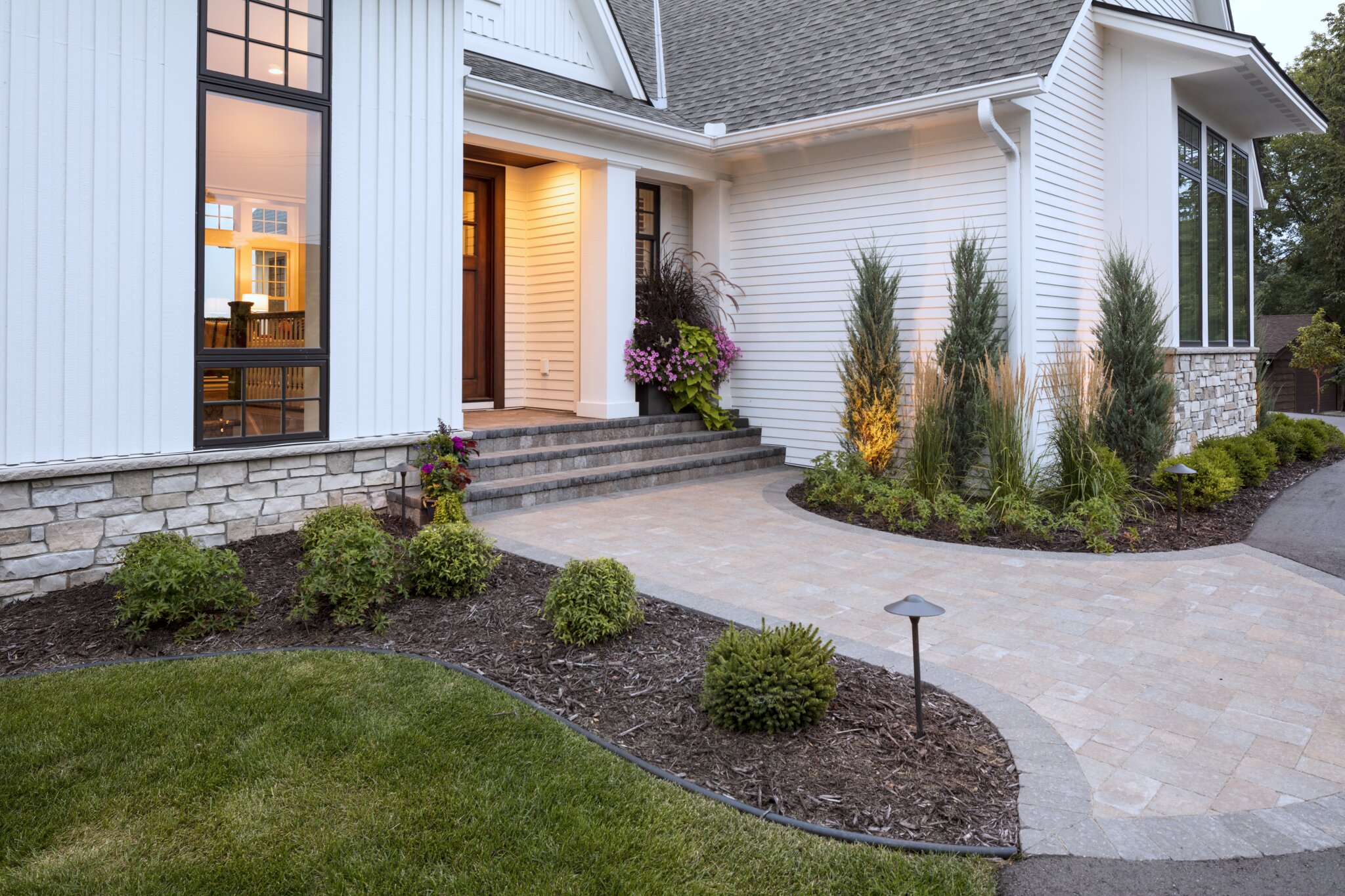 Modern house entrance with landscaped garden.