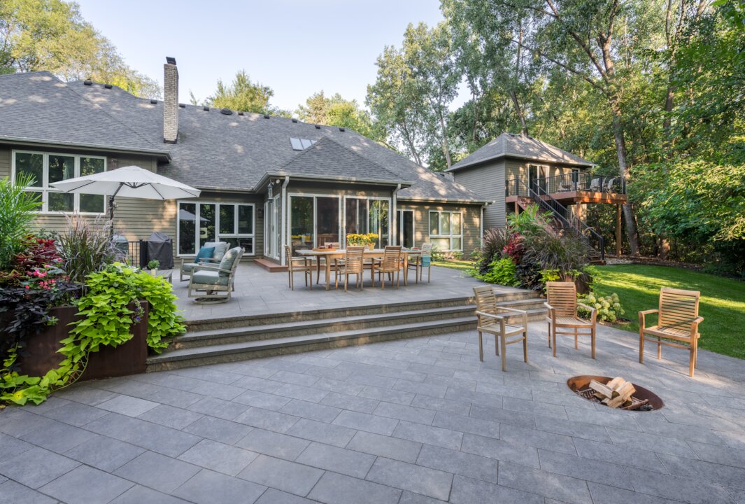 Spacious patio with seating and garden view.