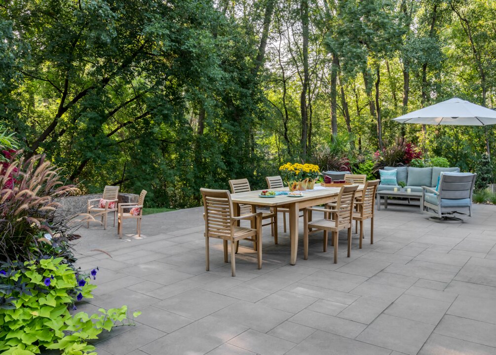 Outdoor patio with dining table and greenery