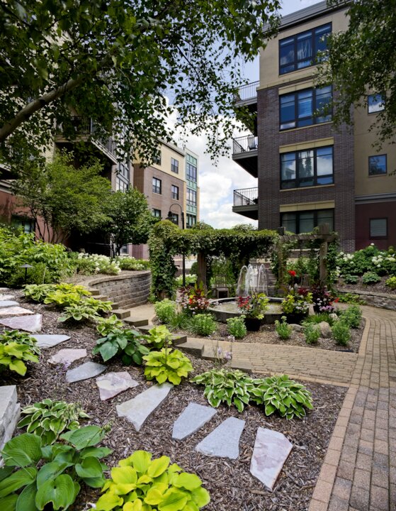 Urban garden with path and fountain.
