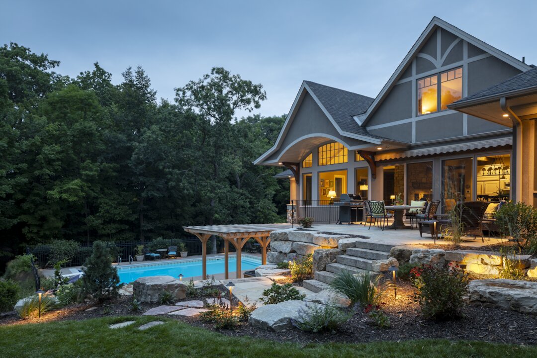 Beautiful house with backyard pool at dusk.