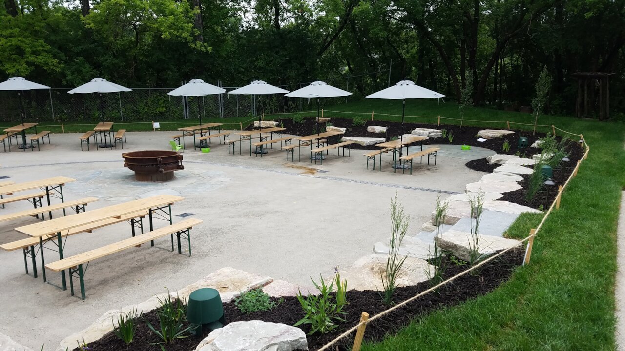 Outdoor seating area with tables and umbrellas