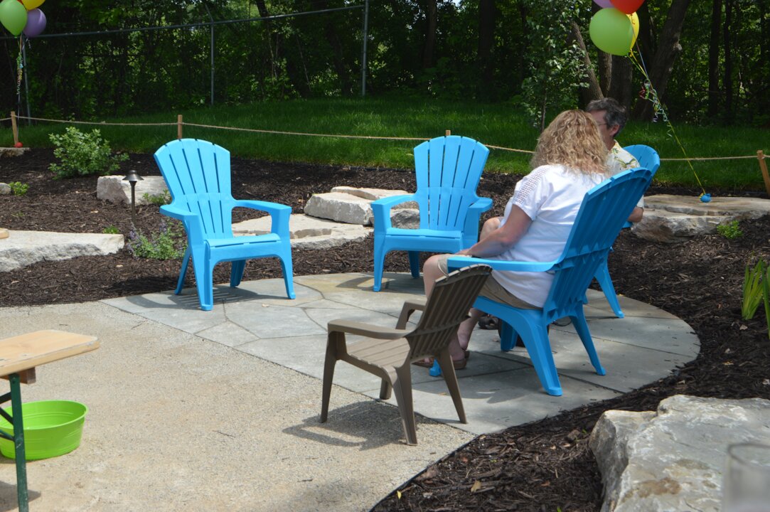 People sitting in blue chairs outdoors
