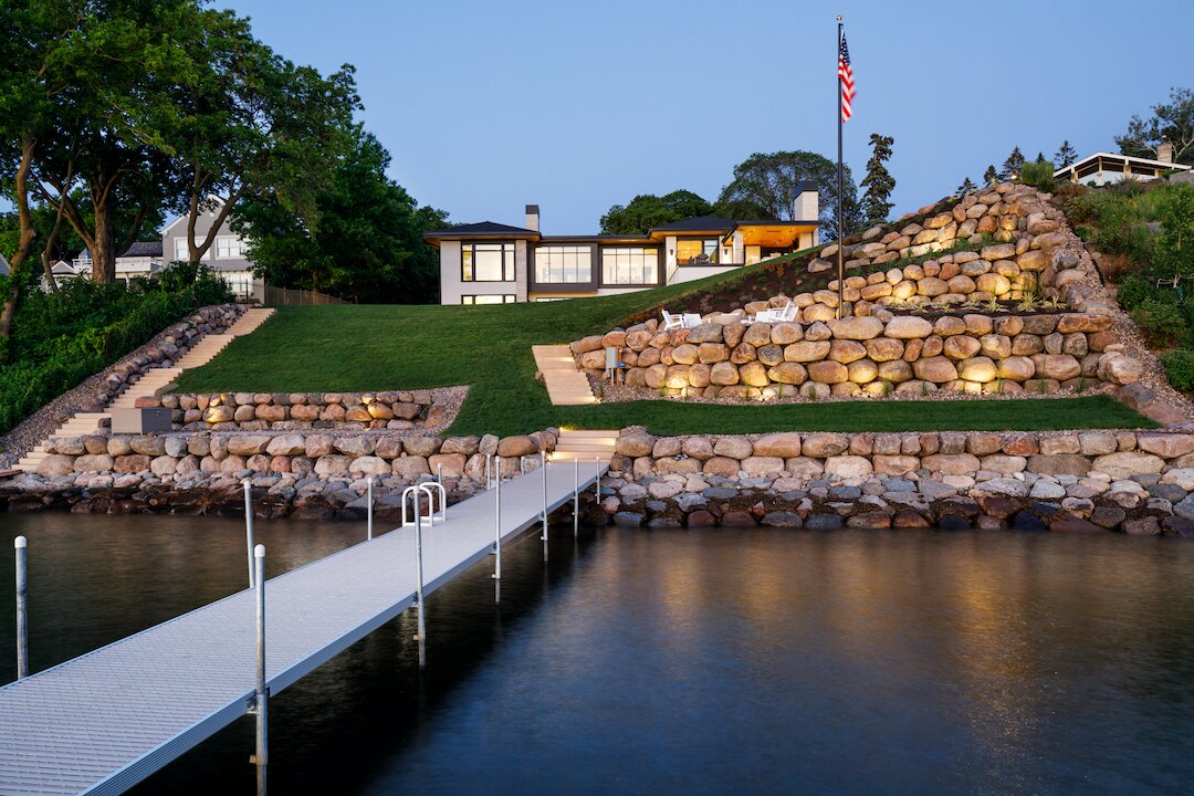 Lakefront house with stone landscaping and dock