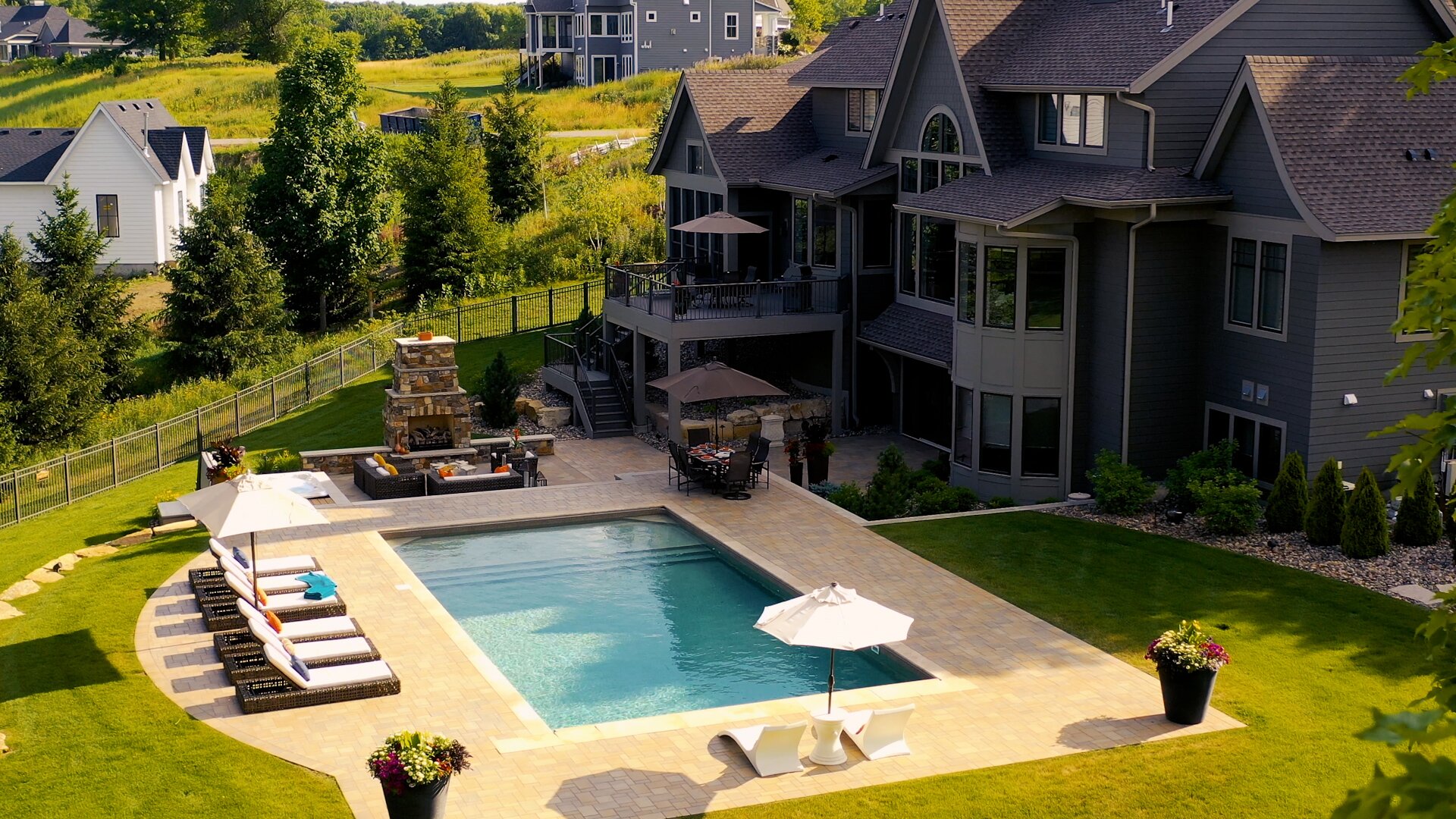 Luxury house with pool and outdoor seating area.