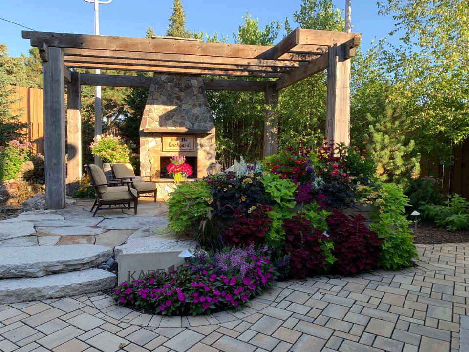 Garden with pergola, fireplace, and colorful flowers