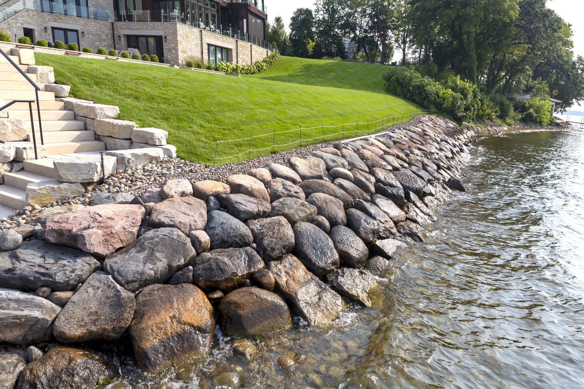 Rocky shoreline with grass and staircase