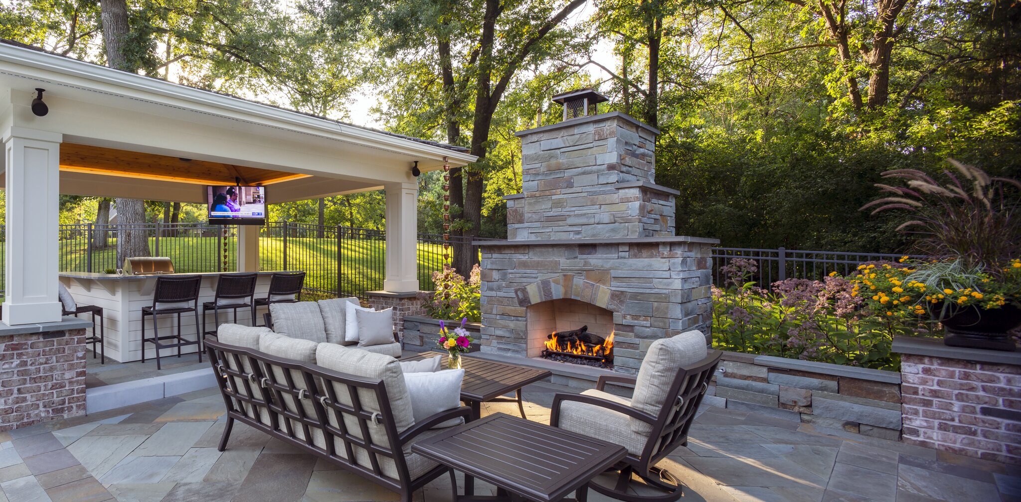 Outdoor patio with fireplace and seating area.