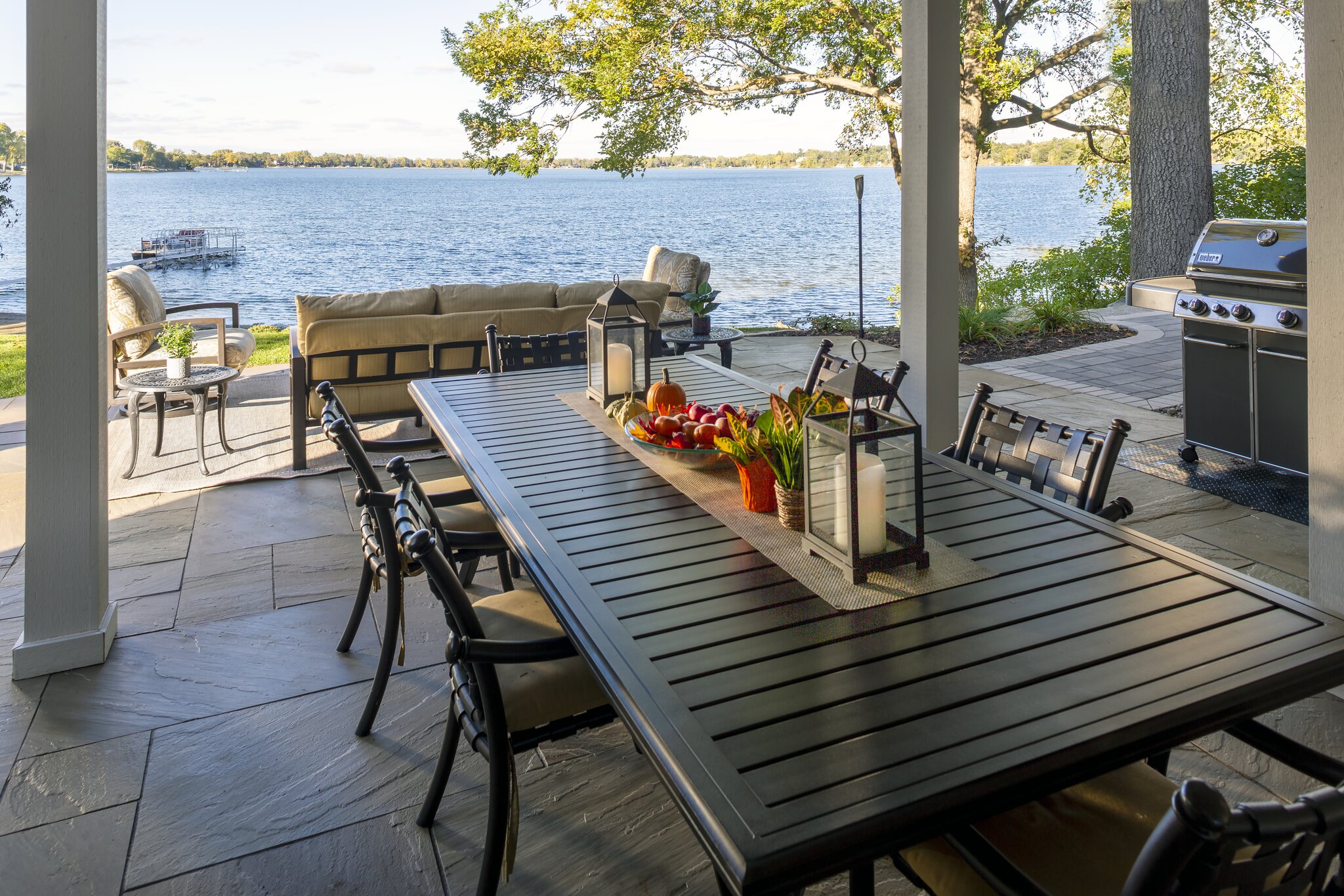 Patio dining with lake view and grill.