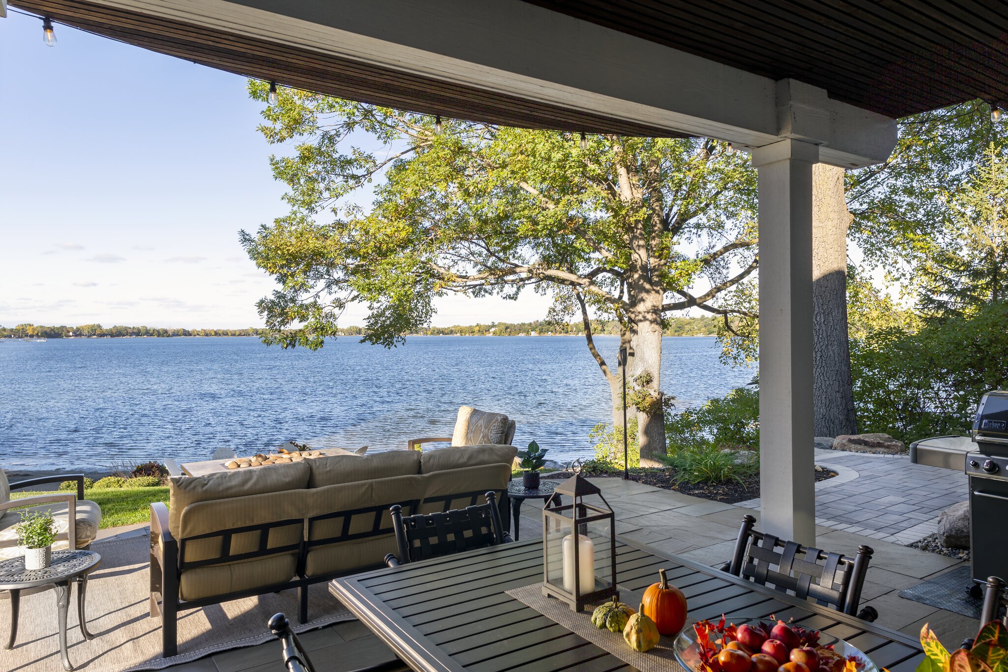 Lakefront patio with furniture and scenic view