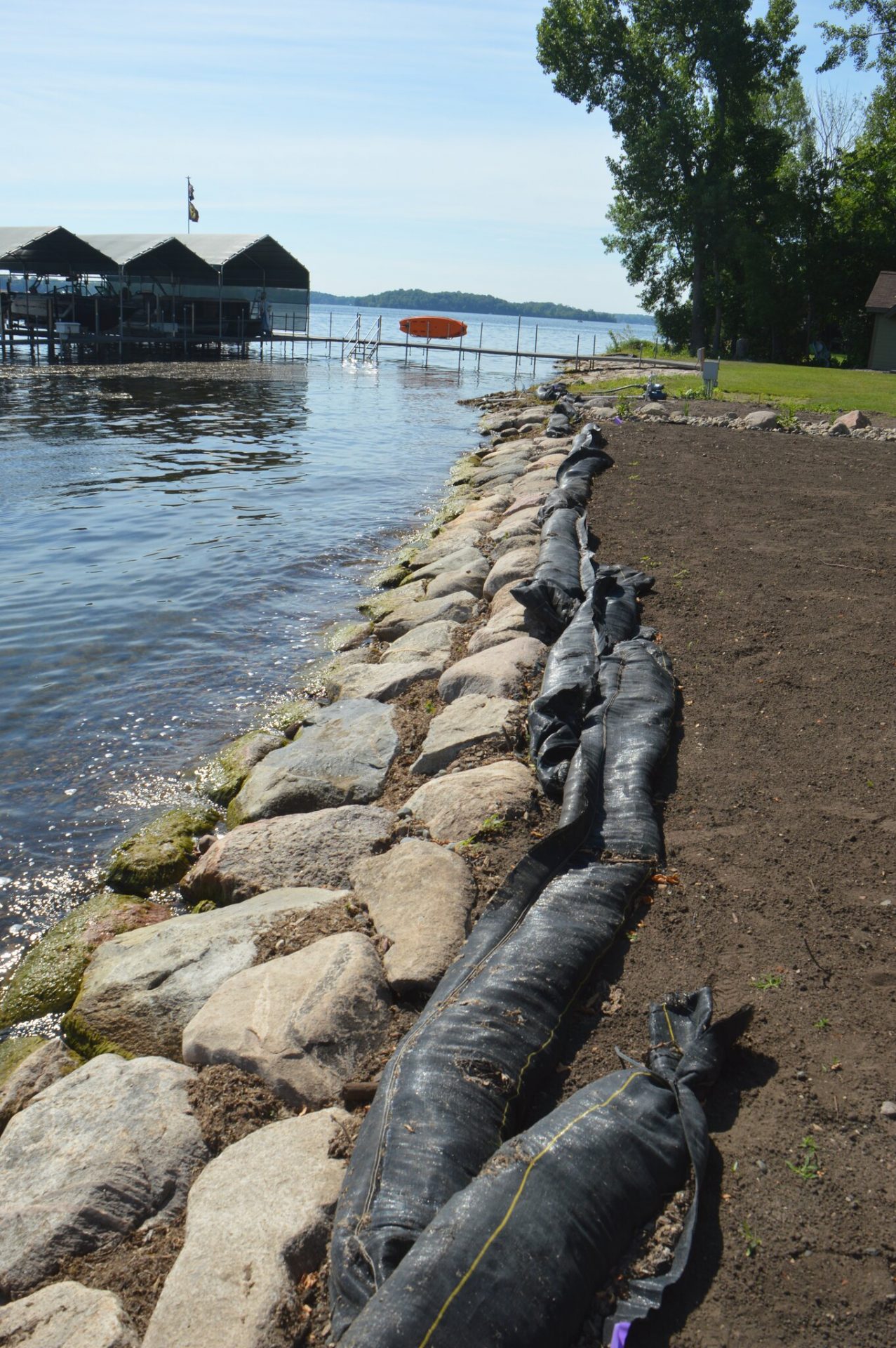 Lake shoreline with rocks and dock
