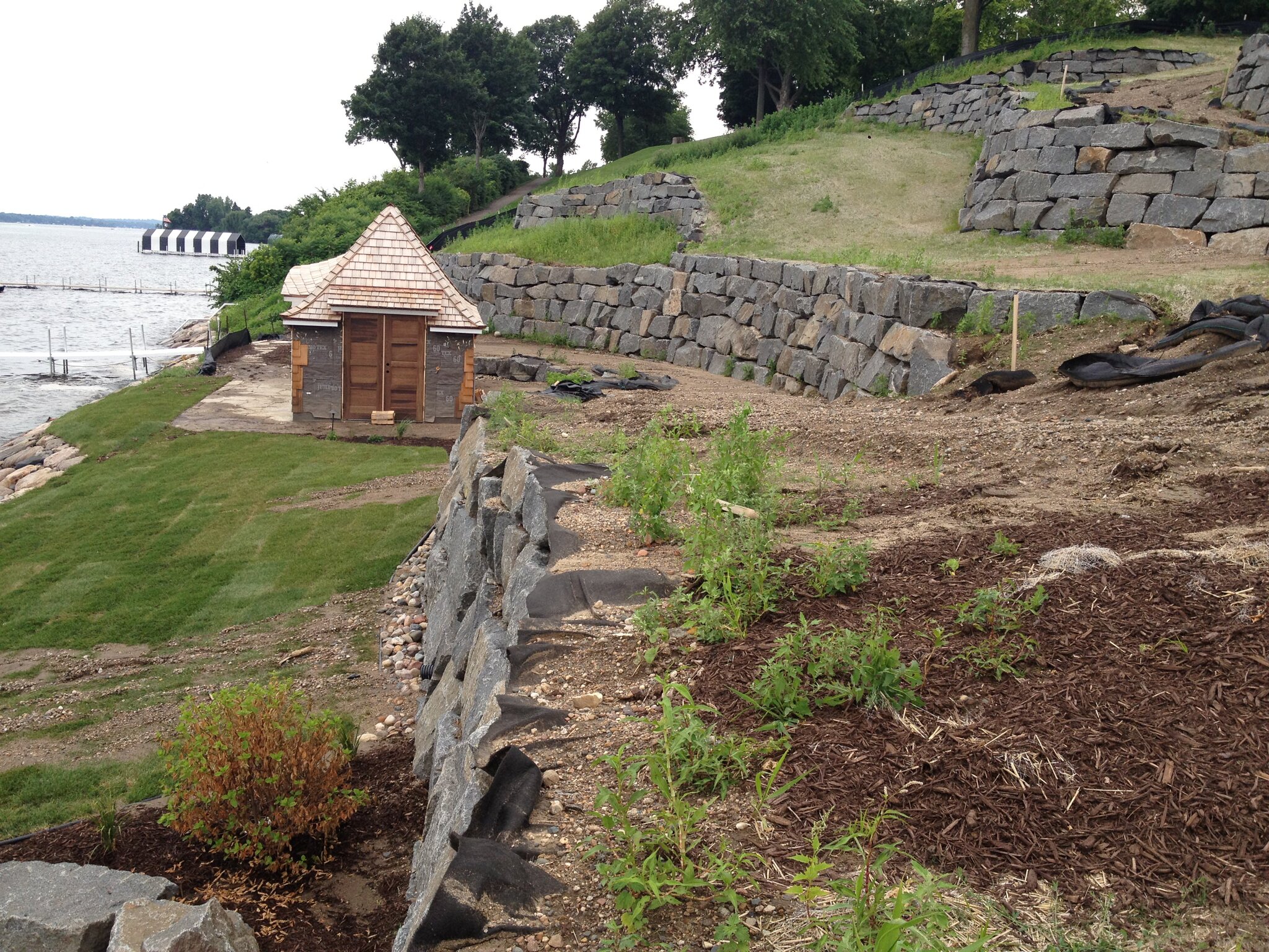 Stone retaining walls near waterfront cabin
