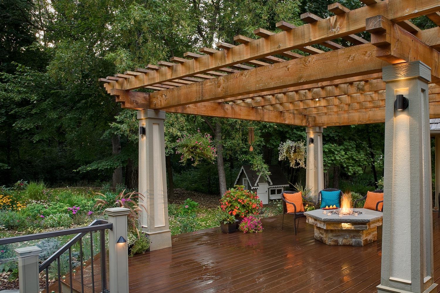 Wooden pergola with deck, outdoor seating, and fire pit.