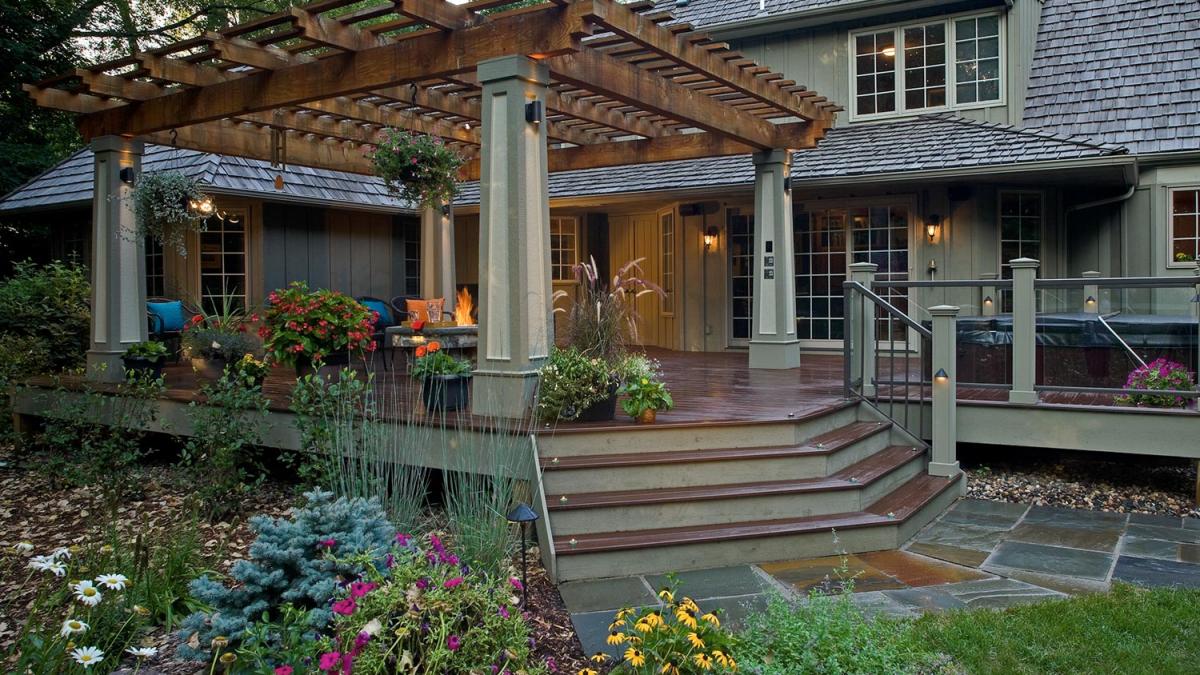 Beautiful wooden deck with pergola and garden view.