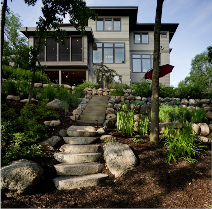 Modern house with garden and stone steps.