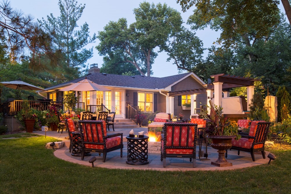 Cozy backyard patio with firepit and seating area.