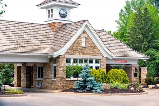 Charming brick building with lush greenery.