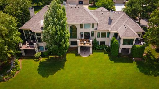 Aerial view of large modern house with garden.