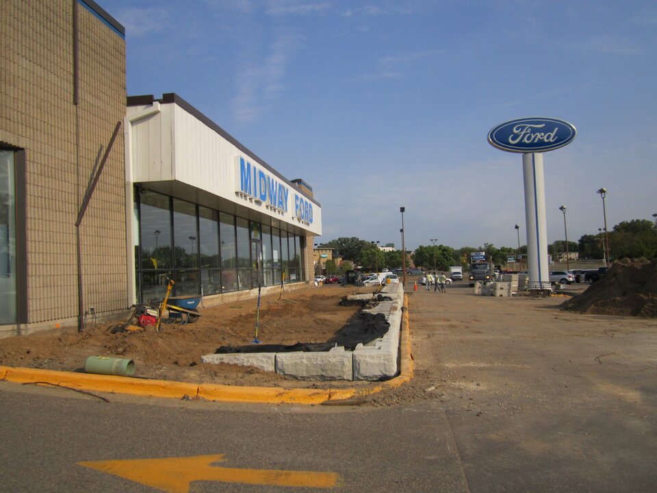 Midway Ford dealership under construction with Ford logo.