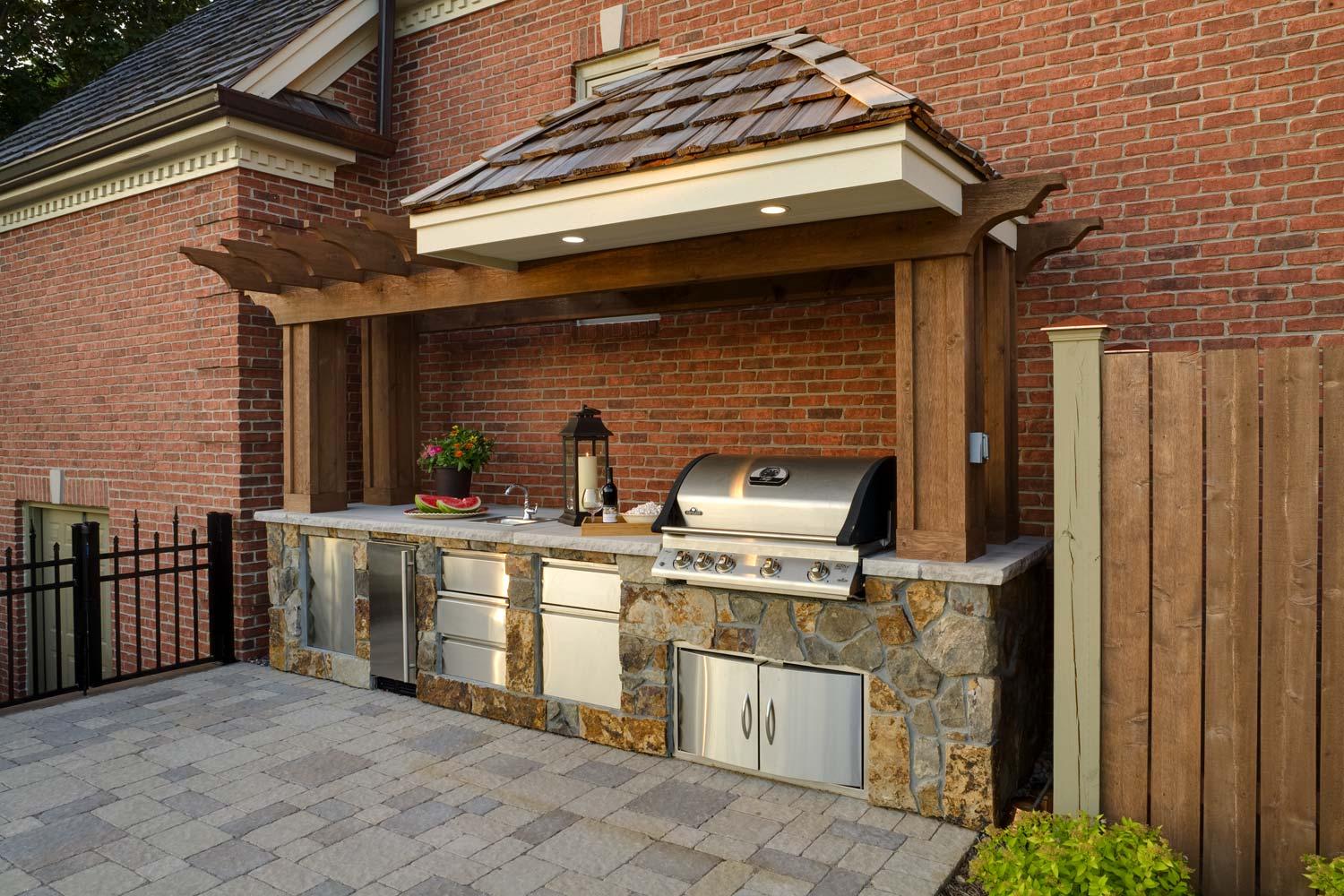 Outdoor kitchen with grill and stone accents