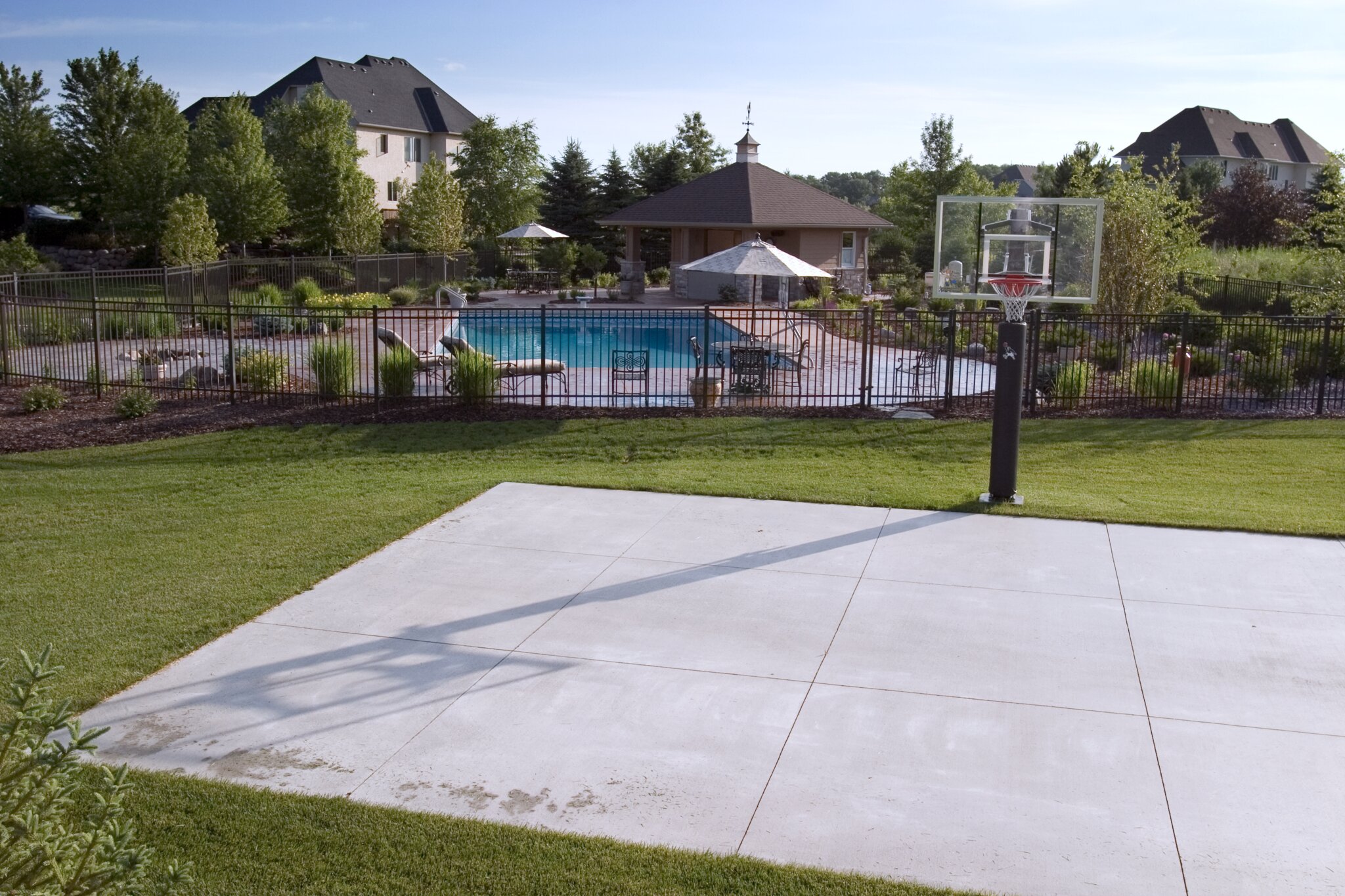 Backyard pool and basketball court scene