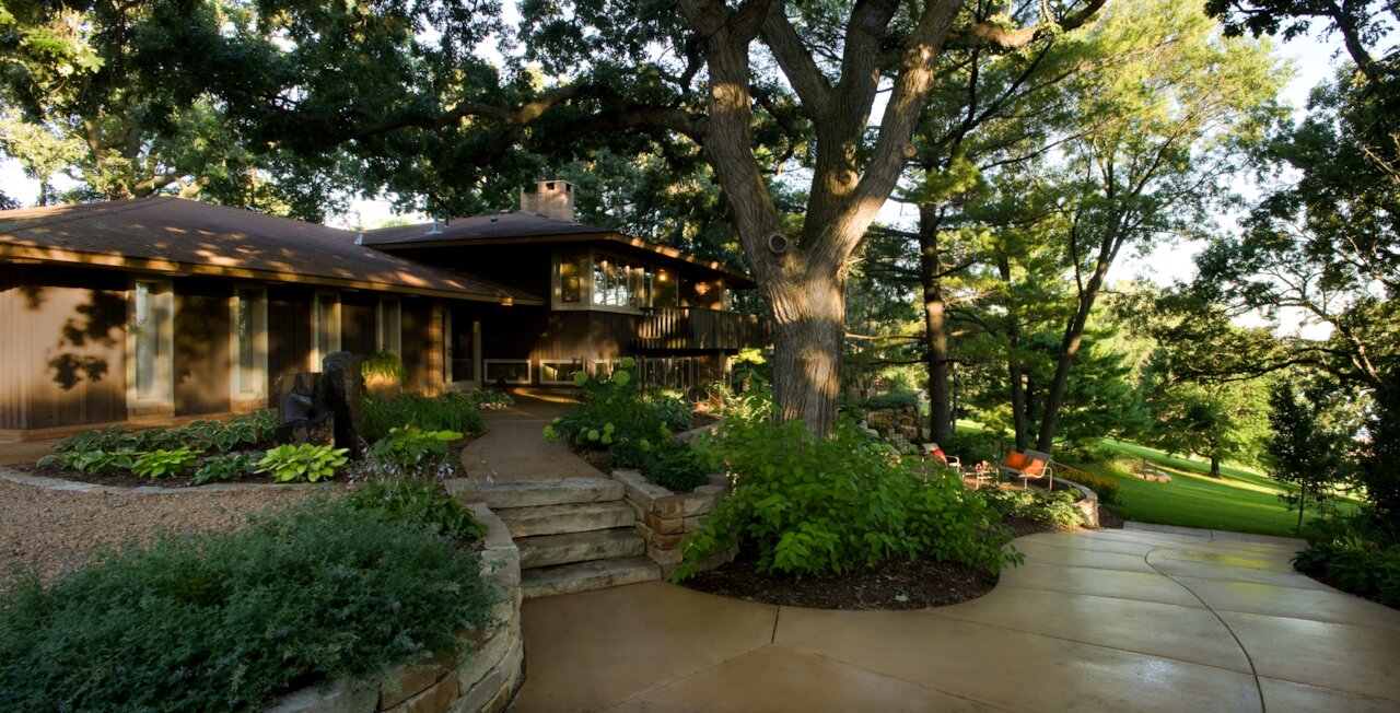 House surrounded by lush trees and garden