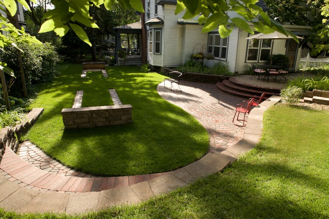 Backyard with patio, lush lawn, trees