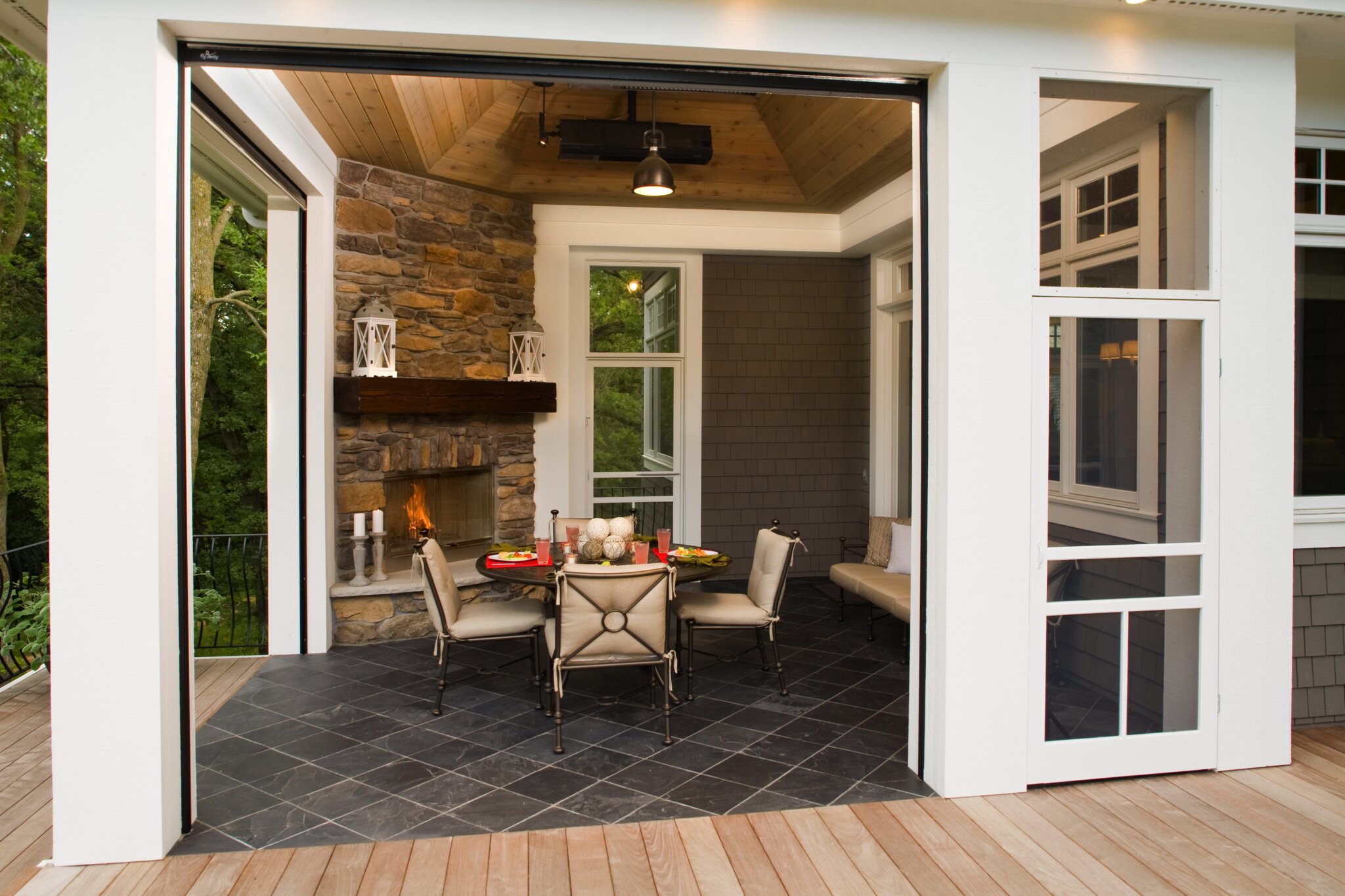 Cozy outdoor patio with fireplace and dining table.