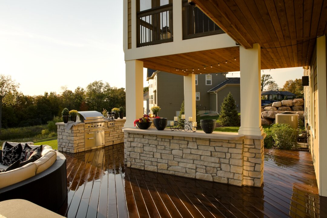 Spacious outdoor patio with grill and seating area.