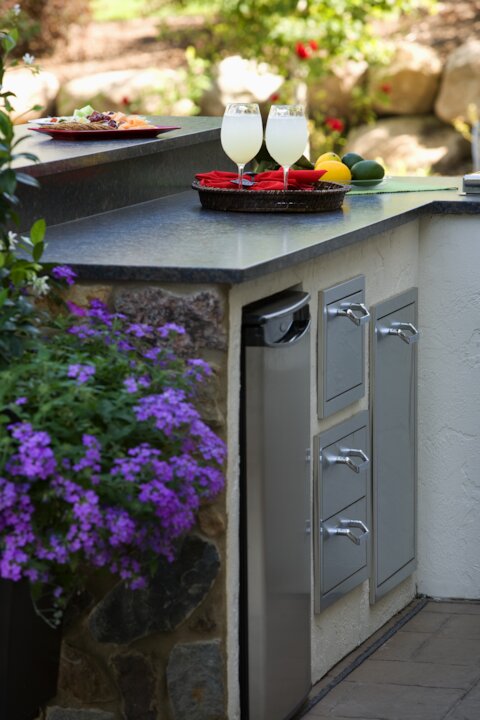 Outdoor kitchen bar with drinks and flowers