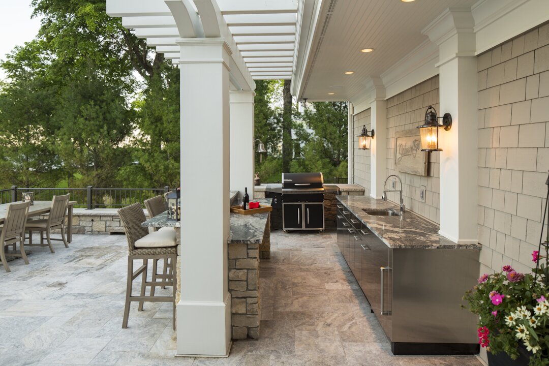 Outdoor kitchen with grill and dining area