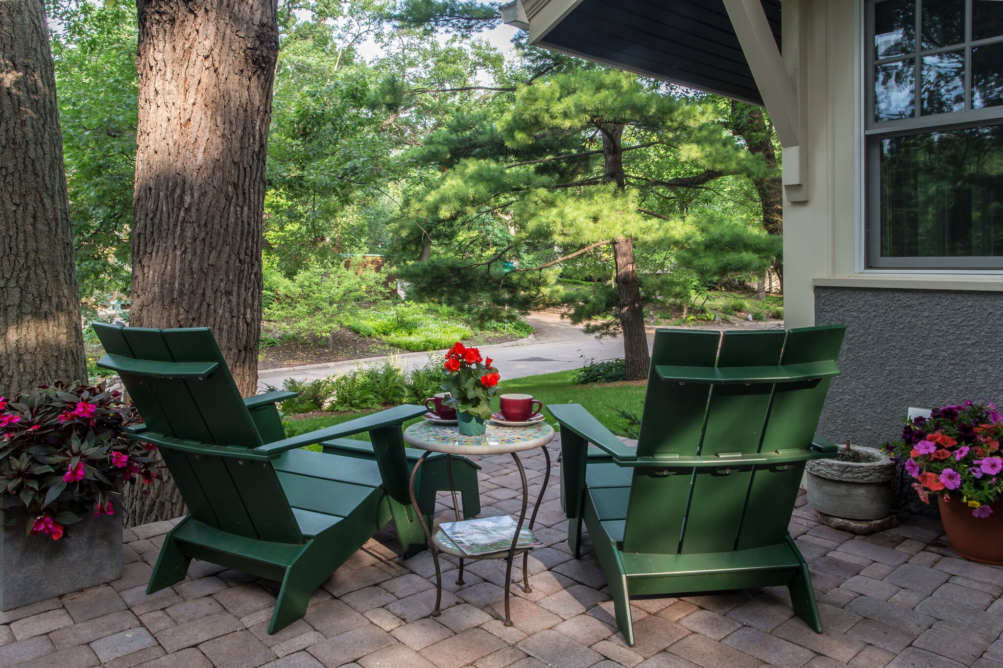 Cozy patio with chairs and flowers in summer.