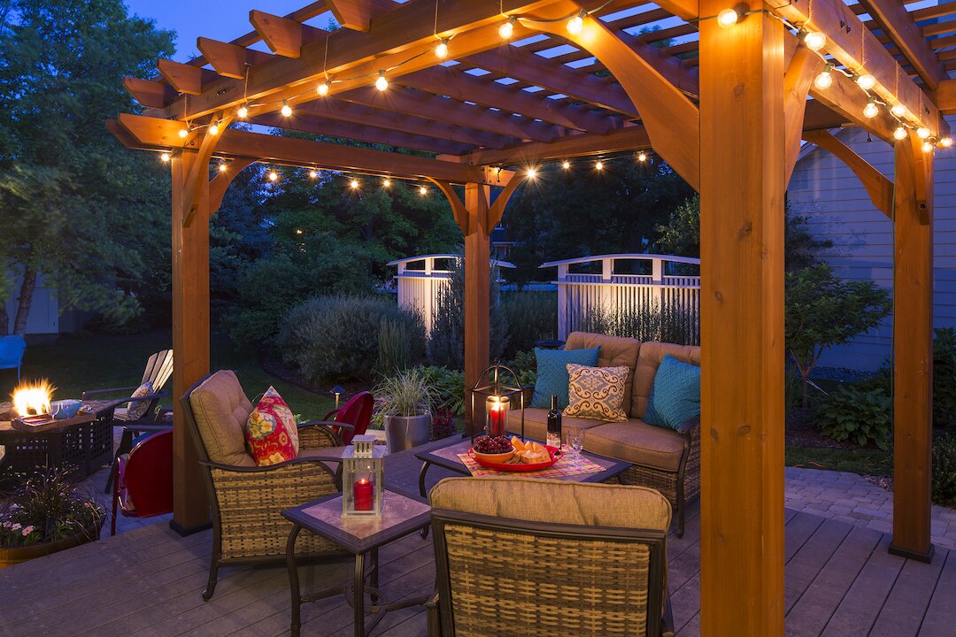 Cozy patio with pergola and string lights.